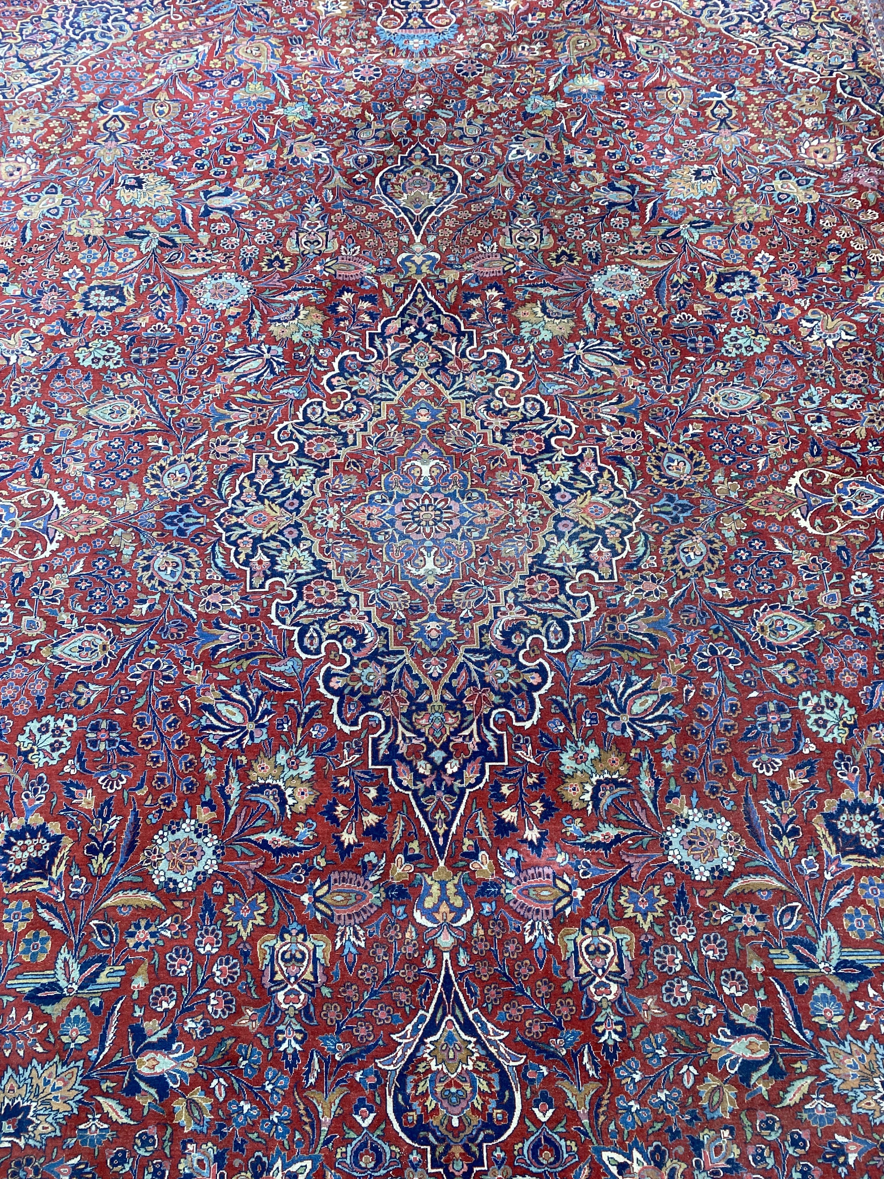 A Tabriz red ground carpet with, first half 20th century, 510cm x 355cm